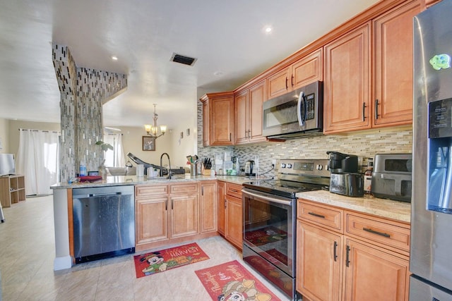 799 Hill Dr Unit F, West Palm Beach, FL 33415 - kitchen featuring stainless steel appliances, a chandelier, tasteful backsplash, light stone counters, and a sink