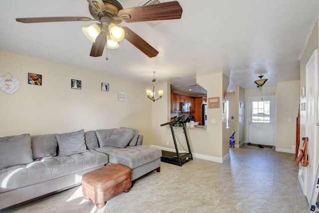 799 Hill Dr Unit F, West Palm Beach, FL 33415 - living area with a ceiling fan, baseboards, and a chandelier