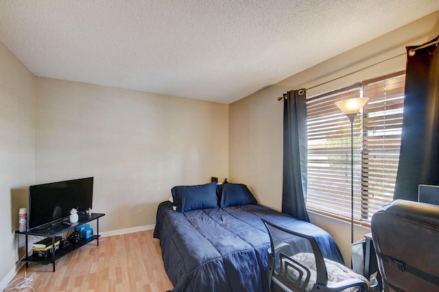 799 Hill Dr Unit F, West Palm Beach, FL 33415 - bedroom featuring wood finished floors, a textured ceiling, and baseboards