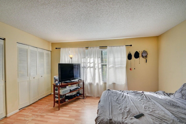 799 Hill Dr Unit F, West Palm Beach, FL 33415 - bedroom with light wood-style flooring and a textured ceiling