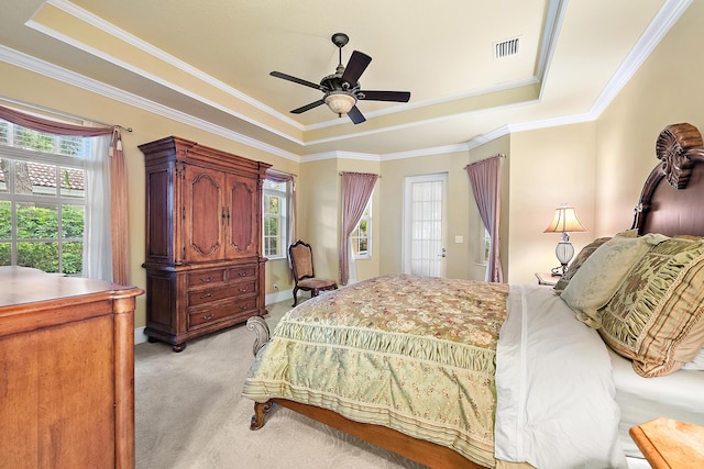 18974 SE Jupiter River Dr, Jupiter, FL 33458 - bedroom featuring a raised ceiling, light carpet, multiple windows, ornamental molding, and a ceiling fan