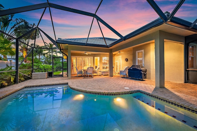 18974 SE Jupiter River Dr, Jupiter, FL 33458 - outdoor pool featuring a patio, a ceiling fan, glass enclosure, and grilling area