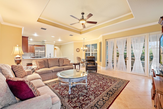 18974 SE Jupiter River Dr, Jupiter, FL 33458 - living room with a raised ceiling, a chandelier, a ceiling fan, light tile patterned floors, and ornamental molding