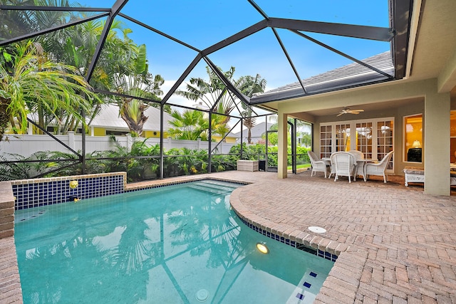 18974 SE Jupiter River Dr, Jupiter, FL 33458 - view of swimming pool with a patio, a ceiling fan, outdoor dining area, and a lanai