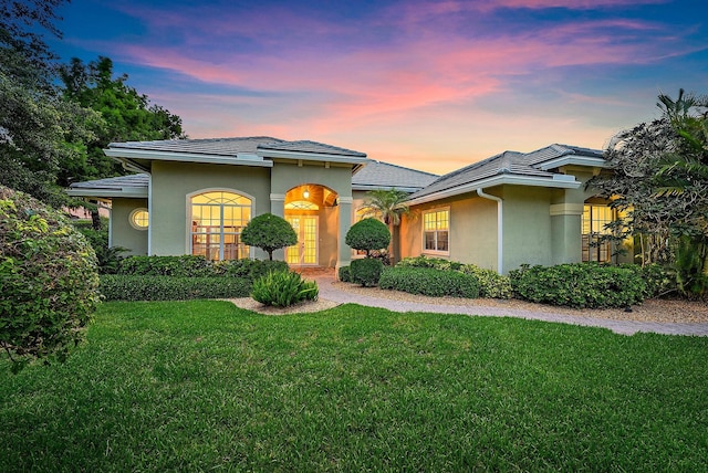 18974 SE Jupiter River Dr, Jupiter, FL 33458 - view of front of property with stucco siding and a front lawn