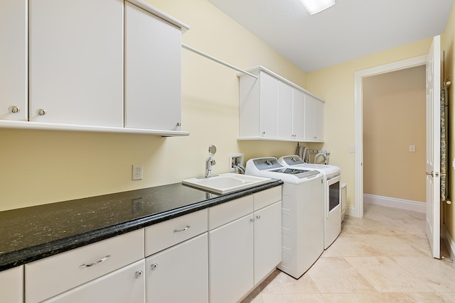 18974 SE Jupiter River Dr, Jupiter, FL 33458 - laundry room with washing machine and clothes dryer, cabinet space, light tile patterned floors, and baseboards