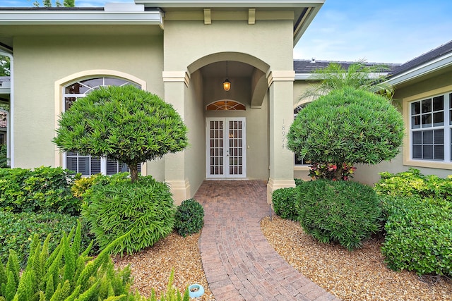 18974 SE Jupiter River Dr, Jupiter, FL 33458 - view of exterior entry with french doors and stucco siding