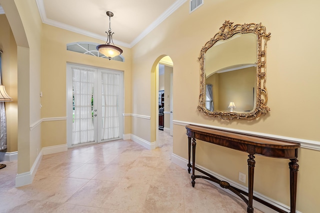 18974 SE Jupiter River Dr, Jupiter, FL 33458 - tiled entrance foyer featuring arched walkways, crown molding, and baseboards