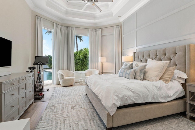 206 Via Emilia, Palm Beach Gardens, FL 33418 - bedroom with wood finished floors, crown molding, a decorative wall, access to exterior, and a ceiling fan
