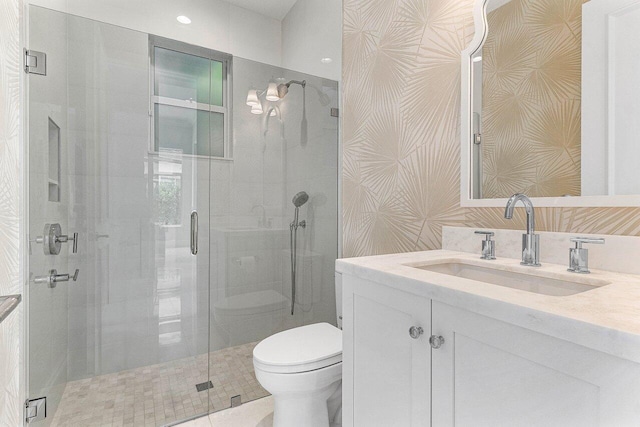 206 Via Emilia, Palm Beach Gardens, FL 33418 - bathroom featuring toilet, vanity, a stall shower, and wallpapered walls