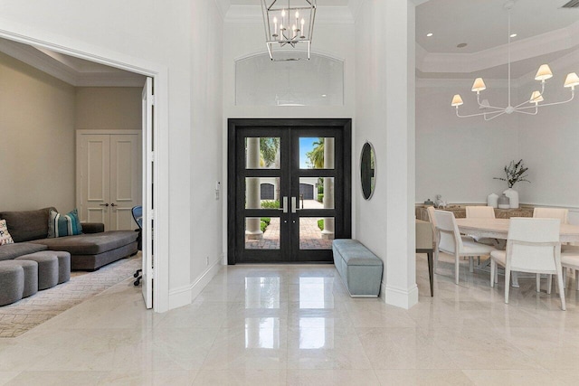 206 Via Emilia, Palm Beach Gardens, FL 33418 - entrance foyer featuring a chandelier, a towering ceiling, ornamental molding, baseboards, and light marble finish floors