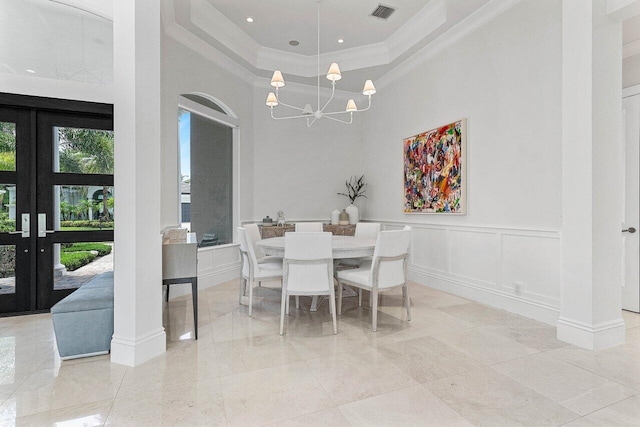 206 Via Emilia, Palm Beach Gardens, FL 33418 - dining area featuring ornamental molding, a chandelier, a high ceiling, a decorative wall, and french doors