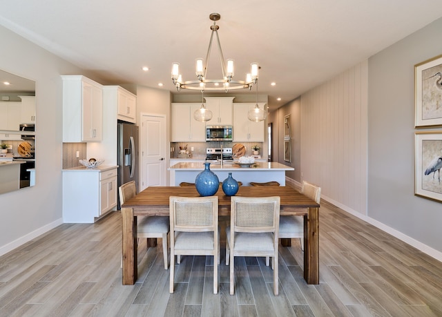 7472 Lenora Ln, Lake Worth, FL 33467 - dining area featuring light wood-style flooring, a chandelier, baseboards, and recessed lighting