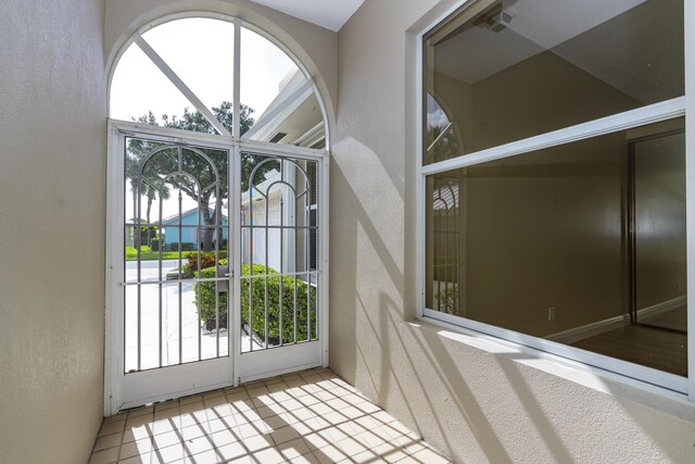 2925 SW Brighton Way, Palm City, FL 34990 - doorway featuring a textured wall and tile patterned flooring