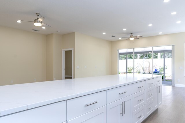 2925 SW Brighton Way, Palm City, FL 34990 - kitchen featuring a ceiling fan, recessed lighting, white cabinetry, and light wood-style floors