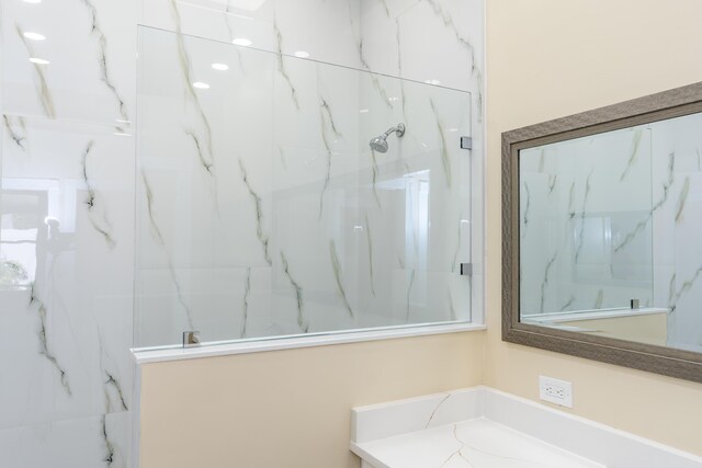 2925 SW Brighton Way, Palm City, FL 34990 - bathroom featuring a marble finish shower and vanity