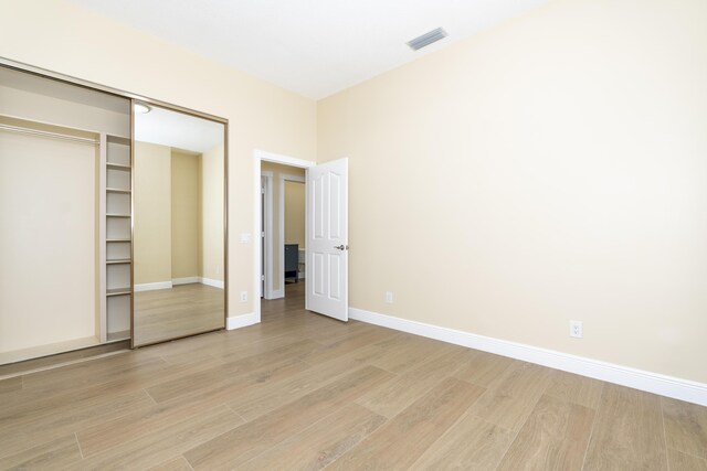 2925 SW Brighton Way, Palm City, FL 34990 - unfurnished bedroom featuring light wood-style floors and a closet