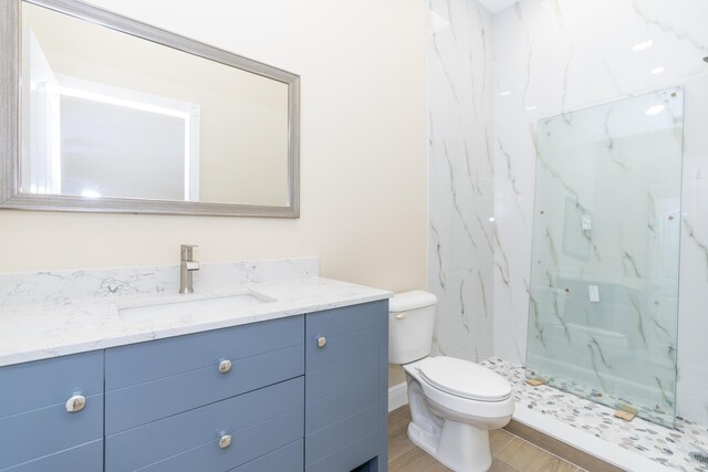 2925 SW Brighton Way, Palm City, FL 34990 - bathroom with vanity, wood finished floors, and a marble finish shower