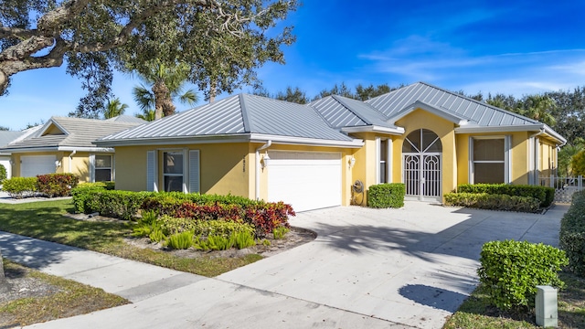 2925 SW Brighton Way, Palm City, FL 34990 - ranch-style home with stucco siding, an attached garage, driveway, a standing seam roof, and metal roof