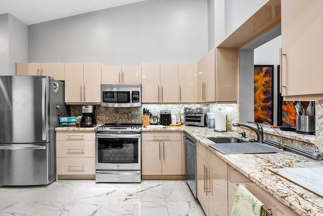 7572 Island Breeze Ter, Boynton Beach, FL 33437 - kitchen featuring stainless steel appliances, tasteful backsplash, light marble finish flooring, a towering ceiling, and light stone counters
