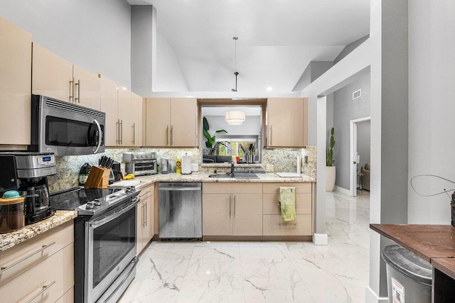 7572 Island Breeze Ter, Boynton Beach, FL 33437 - kitchen with appliances with stainless steel finishes, a sink, tasteful backsplash, light marble finish floors, and light stone counters