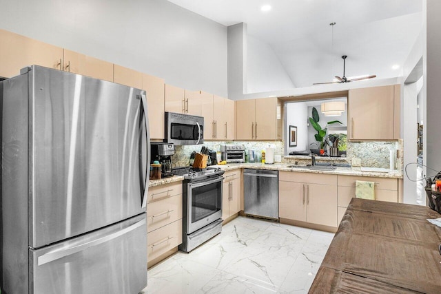 7572 Island Breeze Ter, Boynton Beach, FL 33437 - kitchen featuring appliances with stainless steel finishes, light marble finish flooring, light brown cabinets, a sink, and a ceiling fan