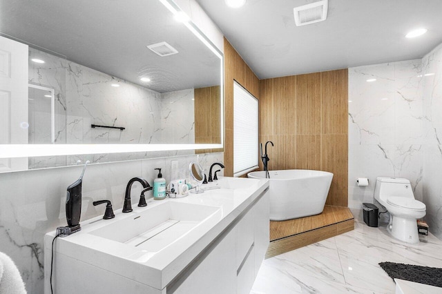 7572 Island Breeze Ter, Boynton Beach, FL 33437 - full bath with tile walls, marble tiled flooring, a soaking tub, double vanity, and toilet
