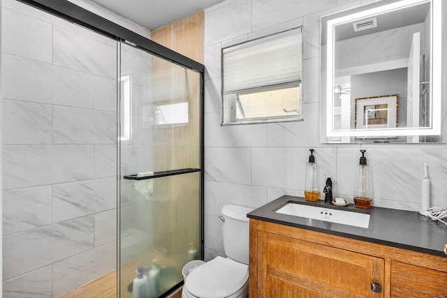 7572 Island Breeze Ter, Boynton Beach, FL 33437 - bathroom featuring tile walls, vanity, a shower stall, toilet, and tasteful backsplash