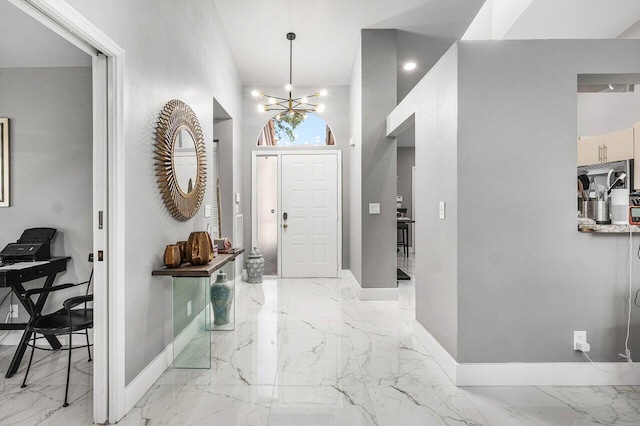 7572 Island Breeze Ter, Boynton Beach, FL 33437 - entrance foyer featuring light marble finish floors, baseboards, and a chandelier