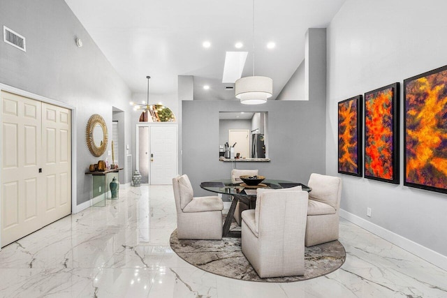 7572 Island Breeze Ter, Boynton Beach, FL 33437 - dining room featuring marble tiled floors, a towering ceiling, baseboards, recessed lighting, and a skylight