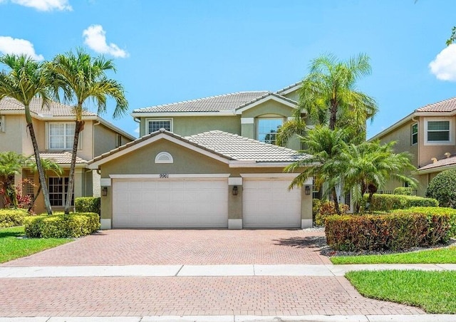 9961 Marsala Way, Delray Beach, FL 33446 - view of front of home featuring a garage, stucco siding, decorative driveway, and a tiled roof