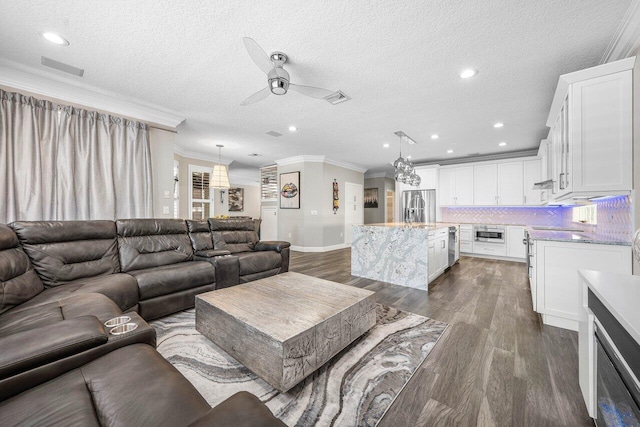 9961 Marsala Way, Delray Beach, FL 33446 - living area featuring crown molding, a ceiling fan, dark wood-style flooring, recessed lighting, and a textured ceiling