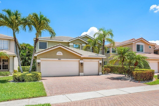 9961 Marsala Way, Delray Beach, FL 33446 - view of front of house featuring decorative driveway, stucco siding, an attached garage, and a tile roof