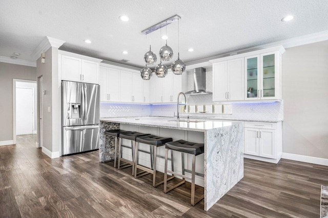 9961 Marsala Way, Delray Beach, FL 33446 - kitchen with stainless steel refrigerator with ice dispenser, crown molding, wall chimney range hood, a sink, and a center island with sink