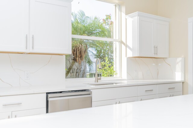 2608 SW Greenwich Way, Palm City, FL 34990 - kitchen with dishwasher, light countertops, white cabinets, and plenty of natural light