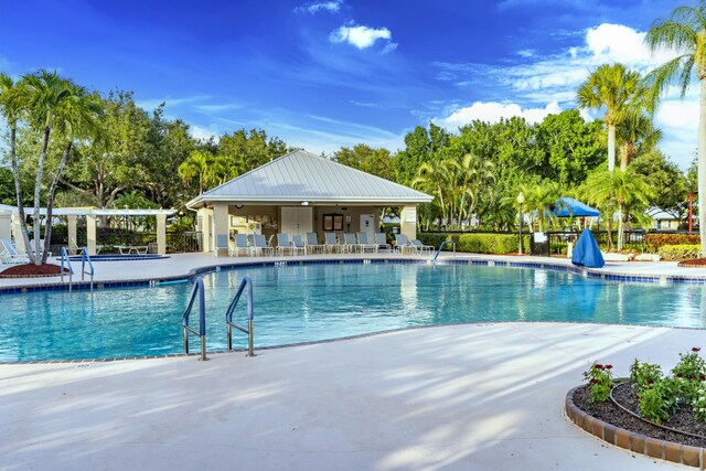 2608 SW Greenwich Way, Palm City, FL 34990 - community pool featuring a patio