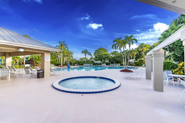 2608 SW Greenwich Way, Palm City, FL 34990 - community pool with a patio and a hot tub