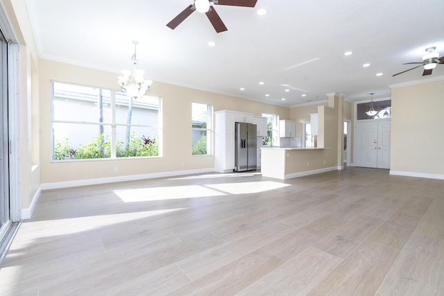 2608 SW Greenwich Way, Palm City, FL 34990 - unfurnished living room featuring a chandelier, a ceiling fan, ornamental molding, recessed lighting, and light wood-style flooring