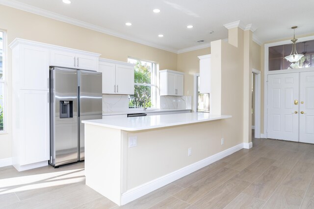 2608 SW Greenwich Way, Palm City, FL 34990 - kitchen with stainless steel fridge with ice dispenser, crown molding, decorative backsplash, recessed lighting, and light countertops