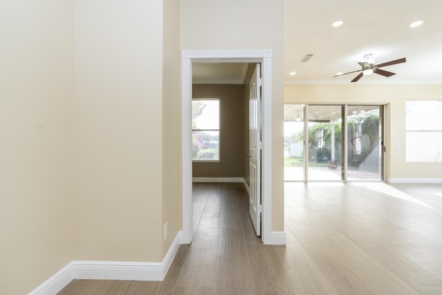 2608 SW Greenwich Way, Palm City, FL 34990 - hallway with ornamental molding, wood finished floors, and recessed lighting