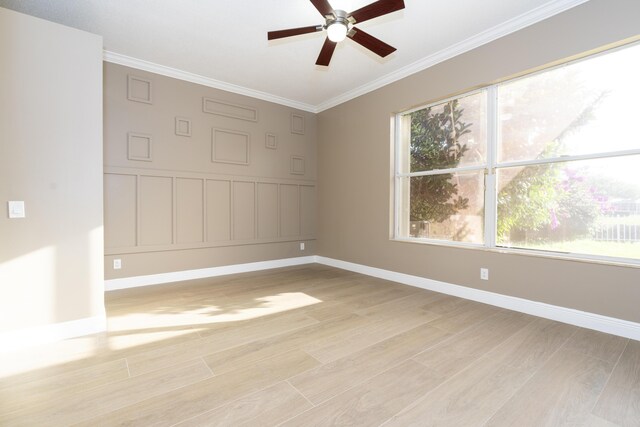 2608 SW Greenwich Way, Palm City, FL 34990 - unfurnished room featuring a ceiling fan, light wood-style floors, crown molding, a decorative wall, and wainscoting