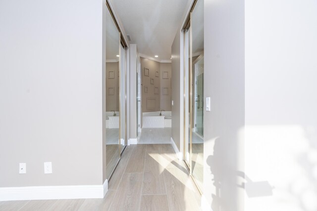 2608 SW Greenwich Way, Palm City, FL 34990 - hallway featuring crown molding and wood finished floors