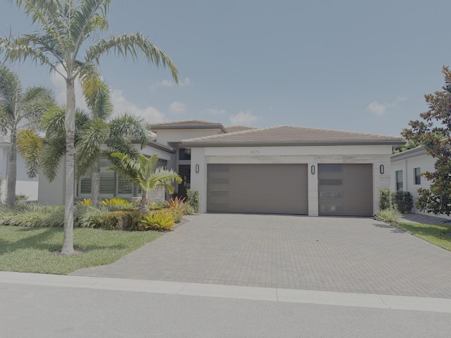 8575 Dearborn River Way, Boca Raton, FL 33496 - view of front of home featuring decorative driveway, an attached garage, and stucco siding