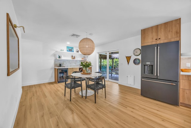 354 Country Club Dr, Tequesta, FL 33469 - dining room with a dry bar, light wood finished floors, baseboards, and beverage cooler