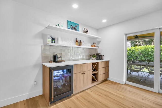 354 Country Club Dr, Tequesta, FL 33469 - indoor dry bar featuring wine cooler, baseboards, light wood-style floors, backsplash, and recessed lighting