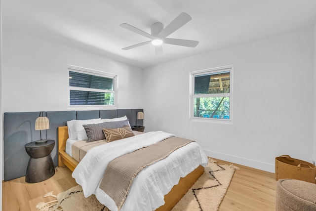 354 Country Club Dr, Tequesta, FL 33469 - bedroom with multiple windows, wood finished floors, baseboards, and ceiling fan