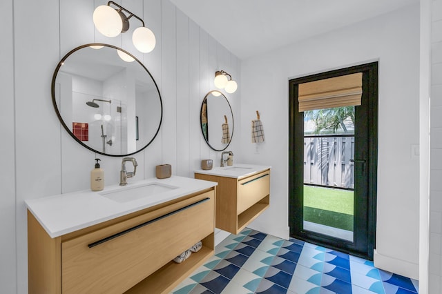 354 Country Club Dr, Tequesta, FL 33469 - full bath featuring a stall shower, tile patterned floors, and two vanities