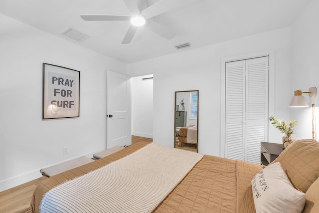 354 Country Club Dr, Tequesta, FL 33469 - bedroom with a closet, wood finished floors, baseboards, and a ceiling fan