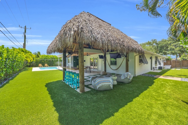 354 Country Club Dr, Tequesta, FL 33469 - rear view of house featuring ceiling fan, a patio area, and stucco siding