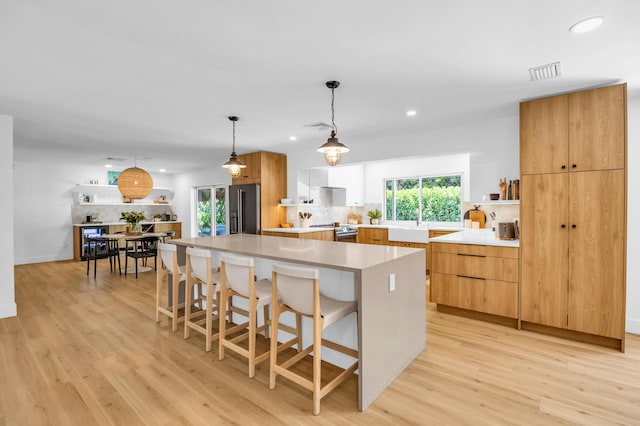 354 Country Club Dr, Tequesta, FL 33469 - kitchen featuring appliances with stainless steel finishes, open shelves, modern cabinets, light wood-type flooring, and recessed lighting